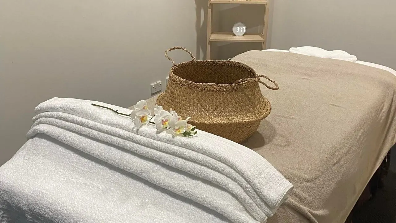 Massage table with a rattan basket and white orchid